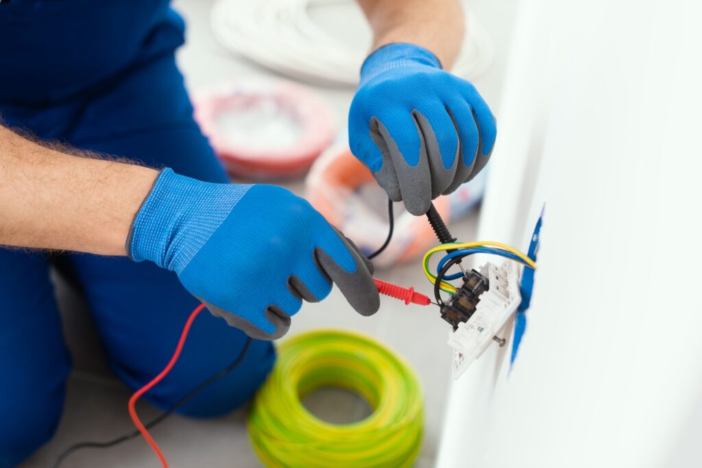 Professional electrician testing an outlet